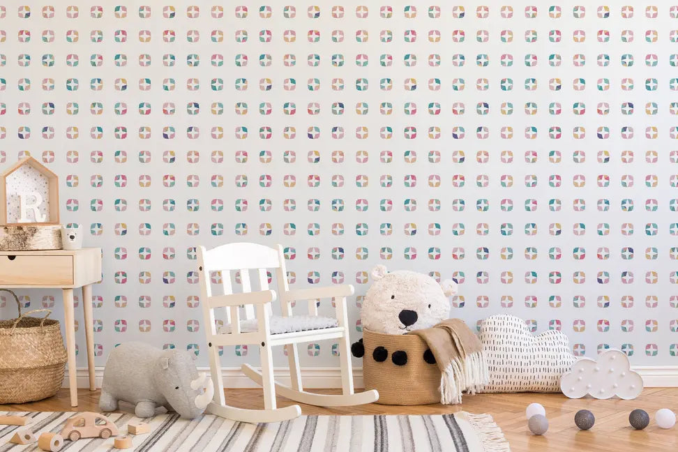 Colorful cloud-patterned wallpaper in pastel shades, featuring a cozy nursery setting with a white rocking chair.