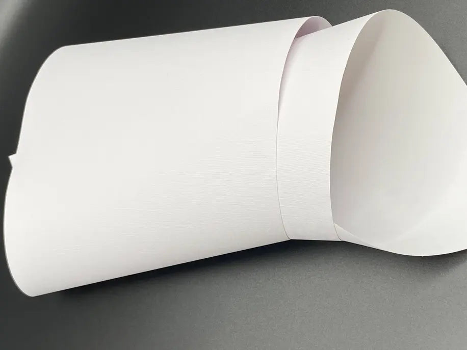 White textured paper cone, perfect for crafts and gift wrapping, featuring a sleek and modern design.