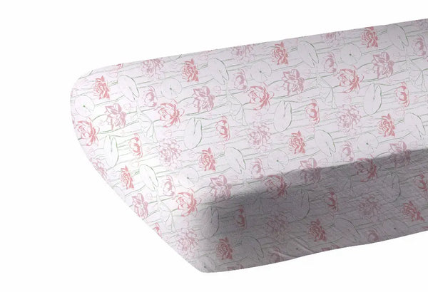 Light pink floral patterned tablecloth made from durable cotton, featuring delicate rose prints on a white background.
