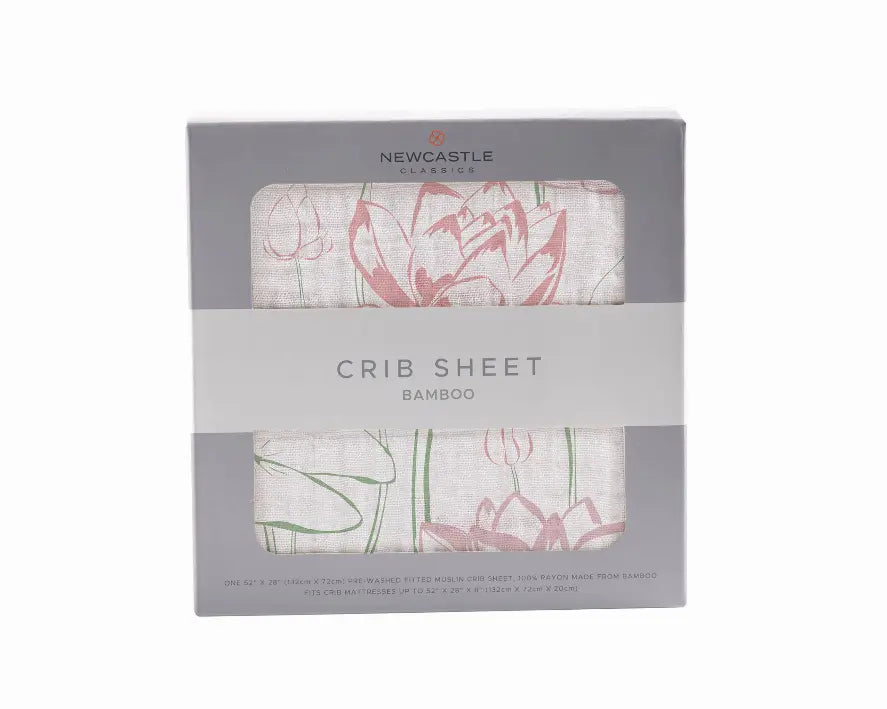 Bamboo crib sheet in soft cream with pink floral design, eco-friendly and breathable for nursery decor.