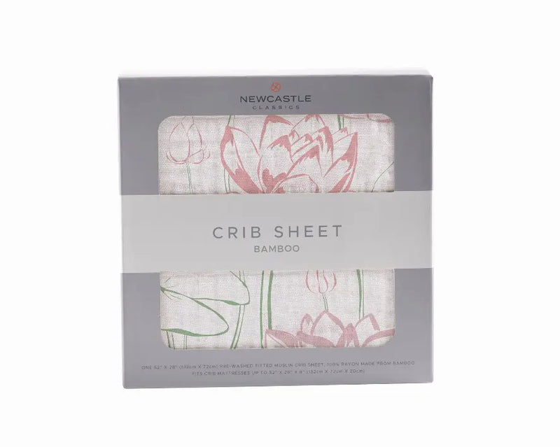 Bamboo crib sheet in soft cream with pink floral design, eco-friendly and breathable for nursery decor.