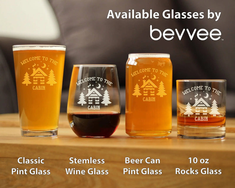 Engraved glasses set: clear stemless wine, classic pint, beer can pint, and rocks glass, featuring a cozy cabin design.