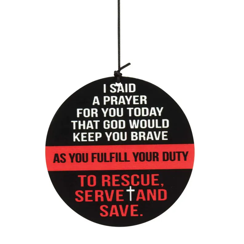 Black circular plaque with red and white text, featuring a cross symbol; inspirational prayer for courage and duty.
