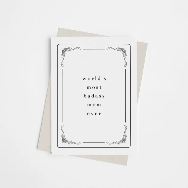 Black and white greeting card with elegant border, featuring "world's most badass mom ever" text, paired with a cream envelope.