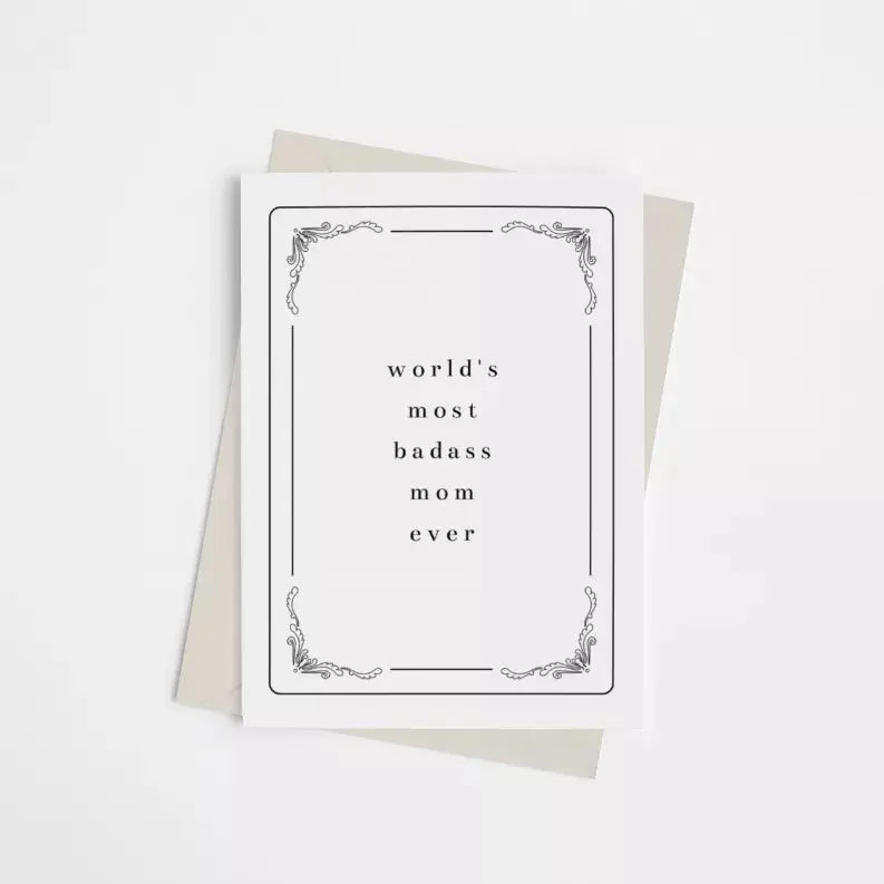 Black and white greeting card with elegant border, text: "world's most badass mom ever," paired with a neutral envelope.