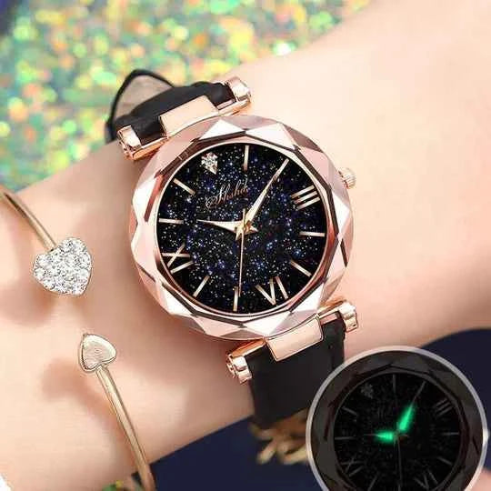 Rose gold wristwatch with black glittery dial and black silicone strap, featuring luminous hands and star accents.